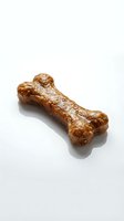 Glazed dog chew treat with knobbed ends on white background, suitable for pet food packaging, veterinary websites, and animal nutrition marketing materials.