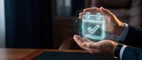 Business professional hands protecting digital security shield with checkmark symbol representing cybersecurity protection and data safety solutions.