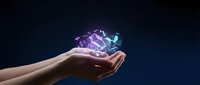 Hand holding glowing neon digital hologram with abstract geometric shapes and light particles floating above palm against dark blue background for technology concepts.