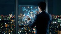 Businessman using futuristic holographic interface with justice scales icons in modern office overlooking city skyline at night for legal technology.