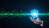Businessman hand holding glowing shield icon with digital network connections on dark blue technology background for cybersecurity protection concept.