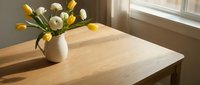 Fresh spring tulips in ceramic vase on wooden table by sunny window creating warm home interior atmosphere for seasonal decoration and lifestyle photography.
