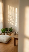 Cozy minimalist living room corner with natural sunlight streaming through window creating geometric shadows on wall with houseplants and wooden table.