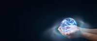 Hands holding glowing digital globe with blue light network connections, representing global technology, innovation, and worldwide business communication.