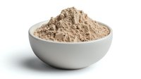 Finely ground protein powder or supplement mix in white ceramic bowl isolated on white background, ready for fitness and nutrition use.