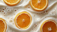 Fresh orange slices with water droplets on creamy silk fabric background for healthy lifestyle and citrus fruit concepts in food photography.