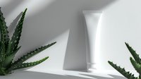 White blank cosmetic tube packaging mockup with aloe vera plants on white background with shadow overlay for skincare product presentation.