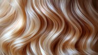 Luxurious wavy blonde and brown hair texture with highlights showing natural flowing movement and shine. Close up of professional hairstyle pattern.