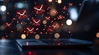 Glowing red warning symbols floating above laptop keyboard with bokeh light effects in dark atmosphere. Digital security concept for cyber threats.