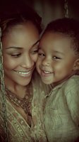 African American mother and young child share intimate moment of joy and laughter in warm vintage-style portrait highlighting genuine emotional connection and family bonds.