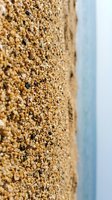 Close-up of textured cork or aggregate surface with warm tan and brown tones, ideal for backgrounds, construction materials, and design projects.