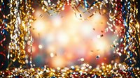 Festive golden and multicolored tinsel garland framing glowing bokeh lights, creating a celebratory atmosphere suitable for holiday cards, party invitations, and seasonal marketing materials.
