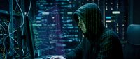 Anonymous hacker in hoodie working on laptop with digital code overlay in dark cybersecurity environment for technology and data protection concepts.