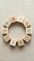 Wooden blocks arranged in circle featuring renewable energy and recycling icons including solar panels, wind turbines, and green symbols on neutral background for sustainability concepts.