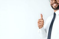 Young African American businessman in white shirt and tie showing thumbs up gesture with confident smile against white background, copy space.