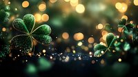 Glowing green shamrock leaves with water drops against dark background with golden bokeh lights creating magical St Patrick's Day atmosphere.