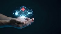 Digital healthcare technology concept with glowing medical icons floating above cupped hands on dark background for telemedicine applications.
