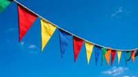 Colorful triangular bunting flags hanging against a bright blue sky, festive decoration for parties, carnivals, and outdoor celebrations.