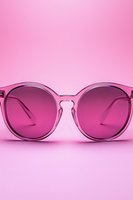 Stylish pink sunglasses with gradient lenses on matching background for fashion and summer accessories concepts.