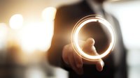 Businessman pointing at glowing circular light effect, symbolizing digital innovation and future technology solutions for business growth.
