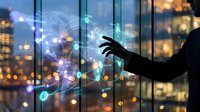 Businessman touching a glowing digital world map with network nodes, representing global connectivity and technology innovation.