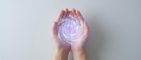 Hands cupping glowing purple energy spiral with magical light effects on white background for healing and spiritual wellness concepts.