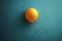Single yellow balloon floating against turquoise wall creates minimalist composition with strong shadow effect, conveying lightness and celebration mood.