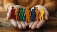 Hands protecting diverse colorful paper cutout figures representing teamwork, inclusion, community support and human resources management.