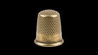 Antique gold metal thimble isolated on transparent background, ready for sewing clipart, craft stickers, print on demand, sublimation, and t-shirt design use.