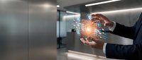 Businessman holding glowing digital network sphere with data connections in modern office environment, representing technology innovation and business solutions.