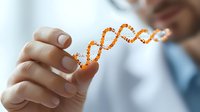 Male scientist in lab coat holding glowing orange DNA helix structure model against blurred background, demonstrating genetic research and biotechnology advancement.