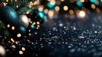 Glittering turquoise and silver Christmas ornaments hanging on pine branches with magical bokeh lights and sparkles on dark background, festive holiday mood.