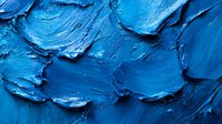 Thick blue oil paint texture with heavy brushstrokes and impasto technique creating dynamic surface for artistic backgrounds and creative projects.