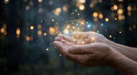 Hands cupping magical golden light particles with sparkling bokeh background for spiritual healing energy concepts and meditation practices.