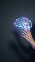 Human hand reaching toward glowing digital brain hologram with neural network connections and bright nodes representing artificial intelligence and innovation.