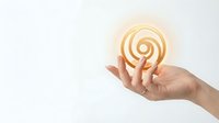 Hand holding glowing lightbulb with spiral filament representing innovation and creative ideas for business solutions and inspiration concepts.