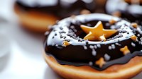 Glazed donut with dark chocolate frosting decorated with golden star sprinkles and white sugar crystals on blurred background, macro food photography.