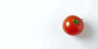 Fresh ripe red tomato with green stem isolated on white background. Perfect for food packaging, recipe blogs, and healthy eating concepts.