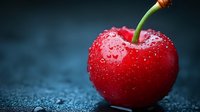 Fresh ripe red cherry with water drops on dark background, macro shot showing details of fruit texture and natural moisture on glossy surface.