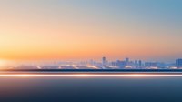 Minimalist cityscape silhouette at sunset with calm ocean waters in foreground, soft orange and blue gradient sky creates peaceful urban panorama.