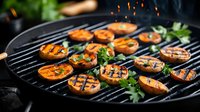 Grilled sweet potato slices with fresh herbs and char marks on black barbecue grate, garnished with parsley against dark background. Food photography.