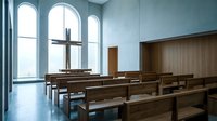Modern minimalist chapel interior with wooden pews, arched windows, and metal cross for worship, meditation, or religious ceremony settings.