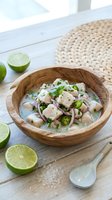 Fresh ceviche with white fish, red onions and cilantro served in wooden bowl with lime halves on rustic table for Latin American cuisine and seafood dishes.