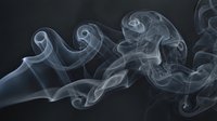 Delicate white smoke swirls curl and twist against a dark background, creating an ethereal abstract pattern for design use.