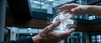 Hands exchanging glowing digital hologram representing data transfer, technology innovation, and business collaboration in modern corporate environment.