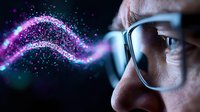 Close up of Asian man in glasses observing glowing purple digital wave pattern, representing artificial intelligence, technology innovation and future vision concept.
