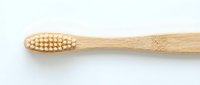 Eco-friendly bamboo toothbrush with natural bristles isolated on white background for sustainable oral hygiene and zero waste lifestyle products.