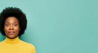 African American woman with natural afro hairstyle wearing bright yellow turtleneck against turquoise background, expressing surprise and joy for lifestyle and portrait use.