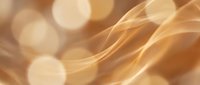 Smooth flowing golden waves with soft bokeh lights create an elegant abstract background for luxury and premium design projects.
