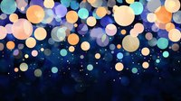 Glowing multicolored bokeh lights floating on dark blue background create magical atmosphere with orange, yellow and turquoise blurred circles and sparkles.